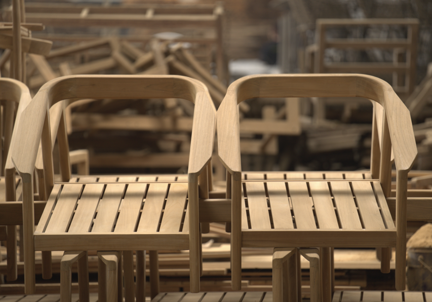 Dining chairs featuring elegant curved armrests, minimalist design, and timeless craftsm